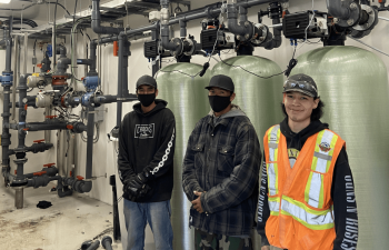 Industra - Kwadacha - Local workers next to water treatment plant system